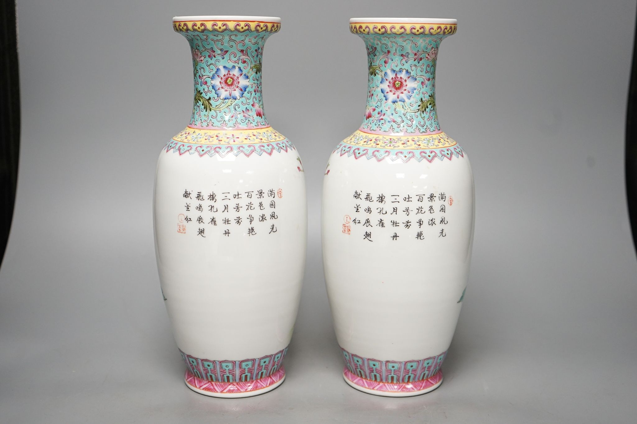 A pair of Chinese famille rose vases decorated with peacocks, 31cm